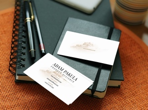 笔记本和钢笔放在一起的商务名片样机模板