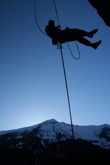 爬山攀岩吊绳索的人剪影图片